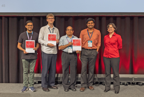 Christie Alappat (left) receiving his third best poster prize, with the other awardees and Research Posters Chair Prof. Estela Suarez