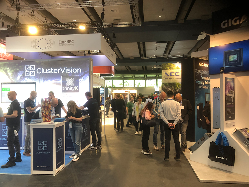An overview over some booths at the HPC exhibition, for example the booth of ClusterVision in the center, also showing some visitors.