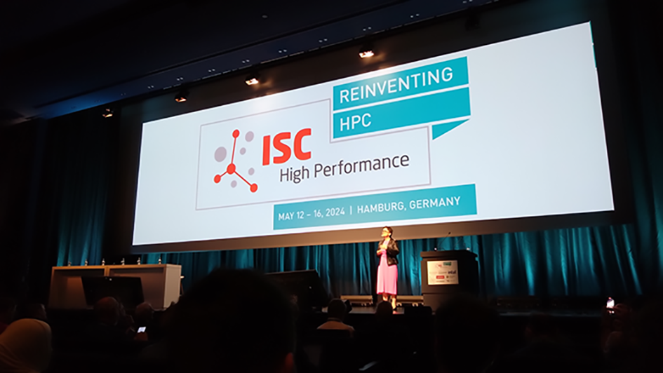 A picture of the presentation stage at the ISC High Performance with Michela Taufer doing a presentation with a big PowerPoint screen.