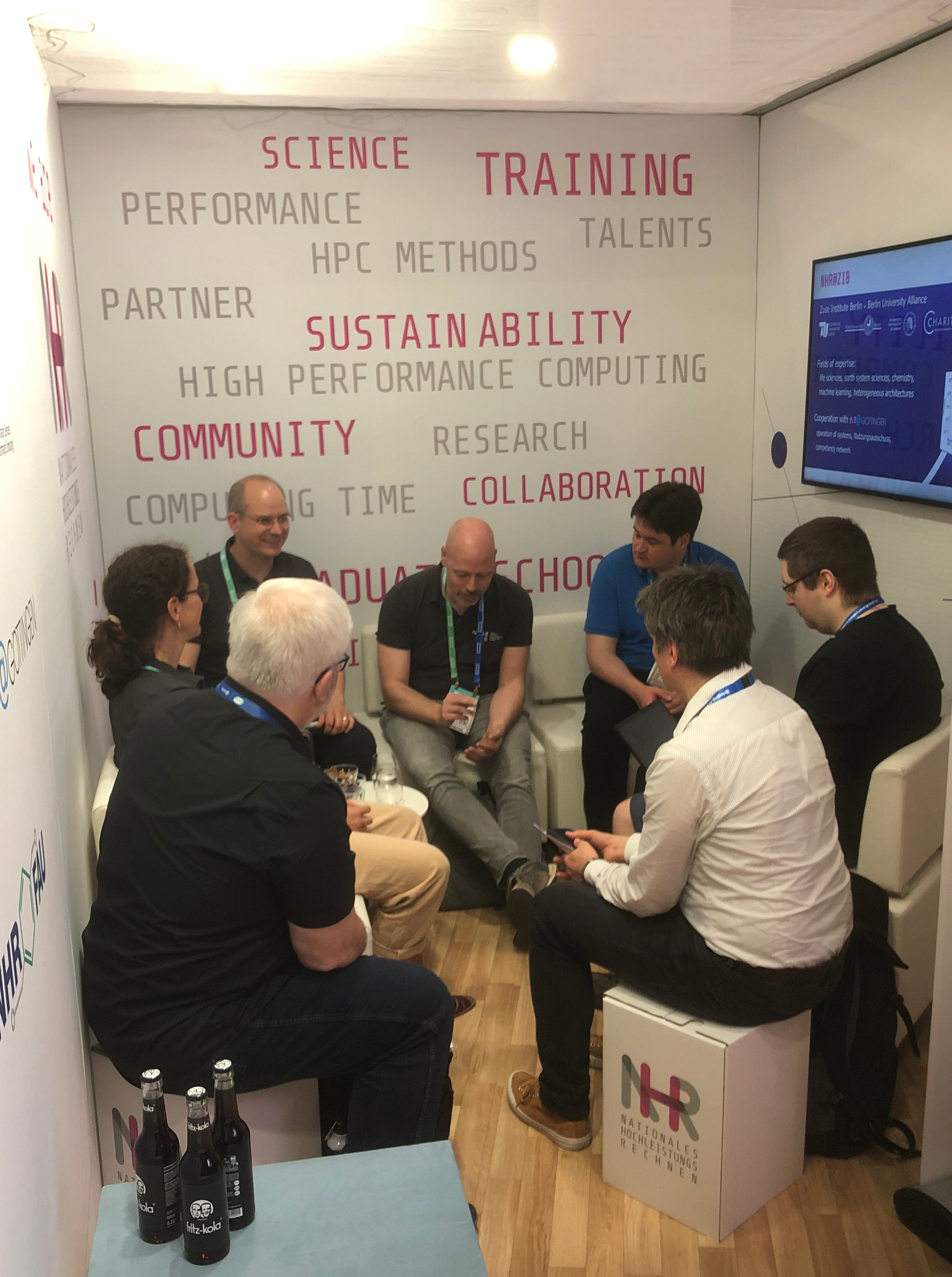 A picture of a group of researchers during a sofa talk at the conference.