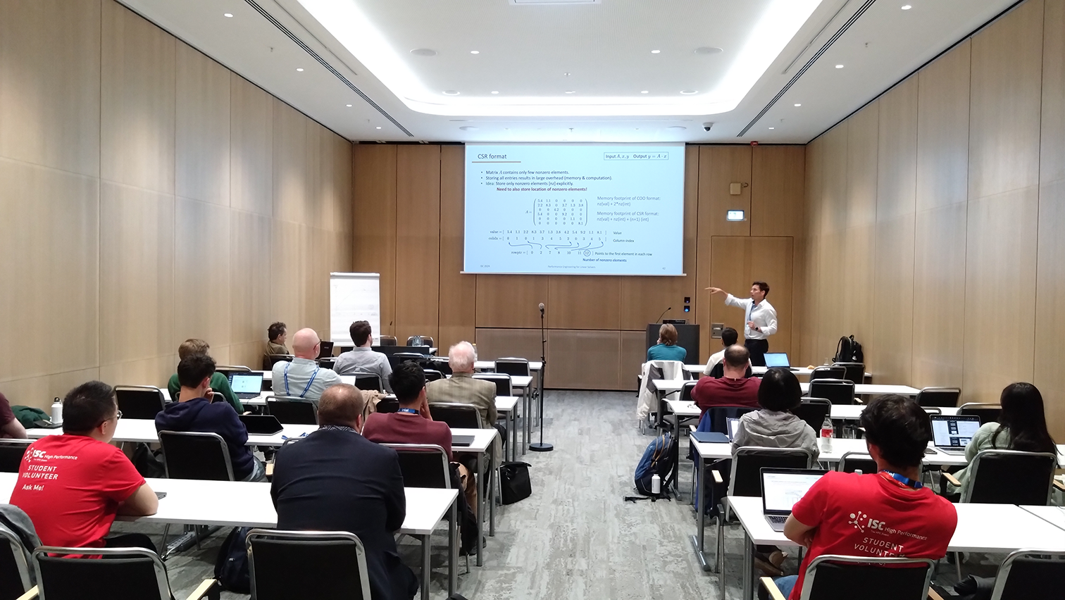 A picture of a seminar room with Hartwig Anzt from TU München presenting in the 