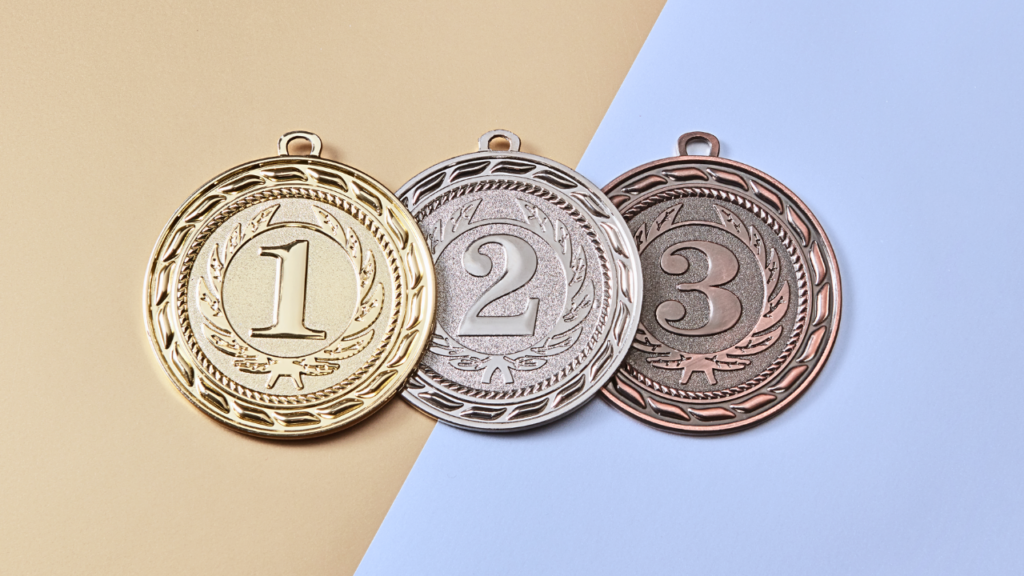 three medals in bronze, silver and gold with the numbers 3, 2 and 1 on them.