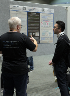 Georg Hager discussing our almost-award-winning poster with an attendee.