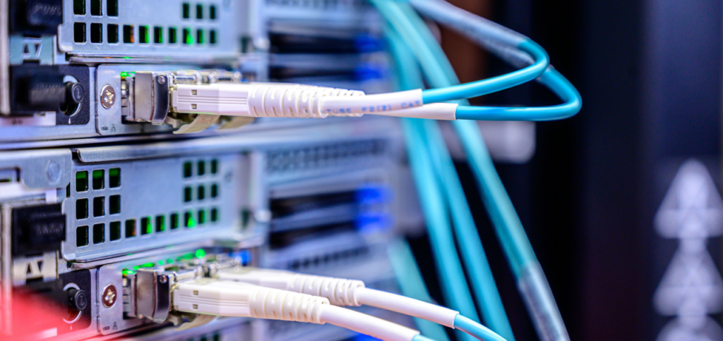Close-up photo of a computer server rack with plugged-in cables.